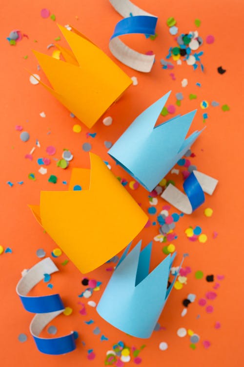Free Paper Cutouts over an Orange Surface Stock Photo