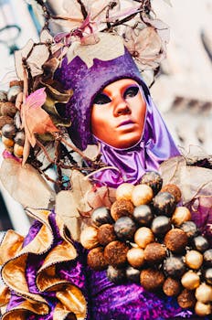 Close-up of a vibrant carnival costume at Venice, featuring intricate headdress and vivid colors.