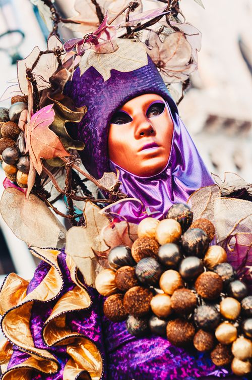 Free Close-up of a vibrant carnival costume at Venice, featuring intricate headdress and vivid colors. Stock Photo