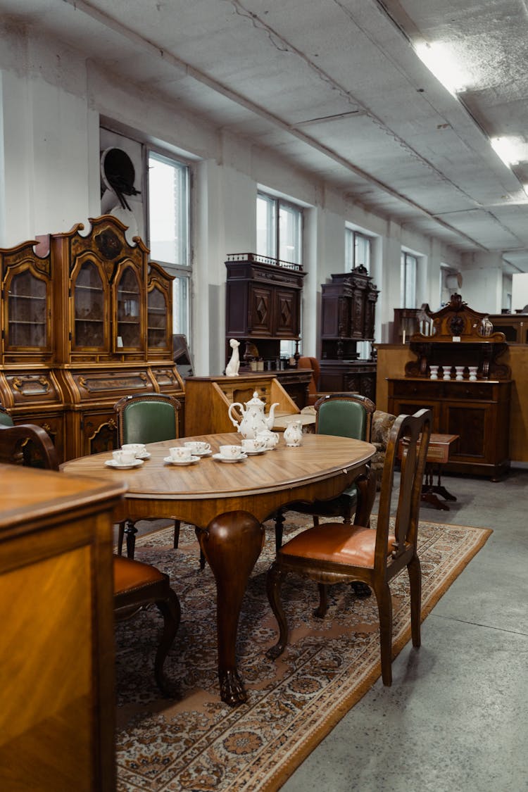 Classic Dining Table And Wooden Cabinets Inside An Antique Shop