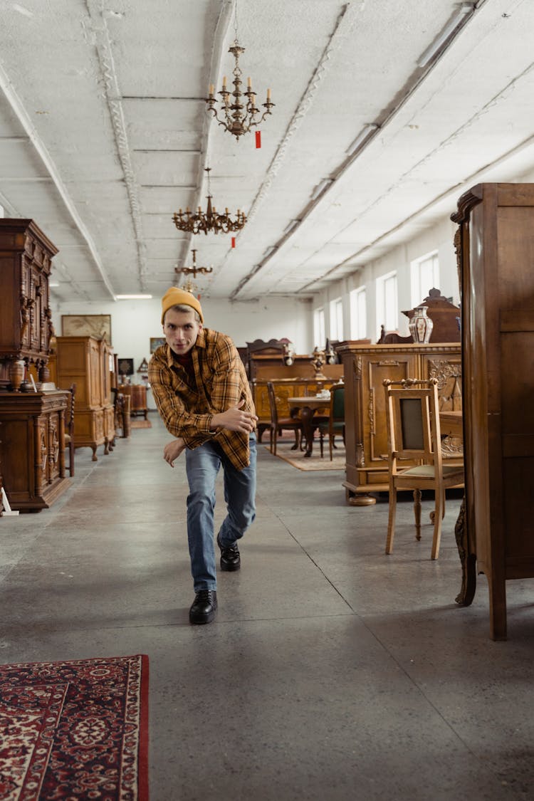 A Man Posing Inside A Furniture Store