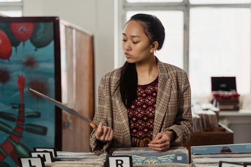 A Woman Looking at an Old Music Record