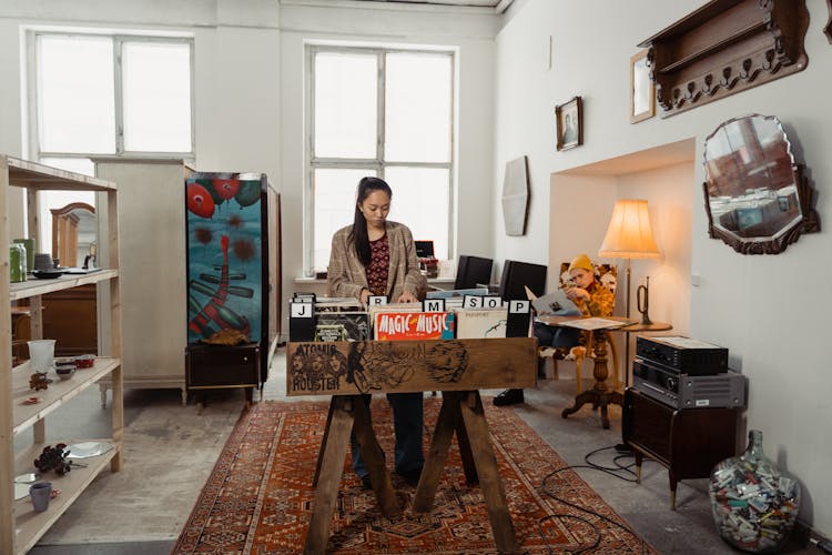 A Woman Looking At Vinyl Records At A Store