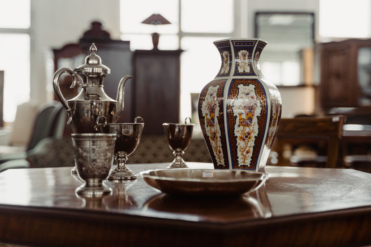 Collection of antique metalware and ceramics on a table
