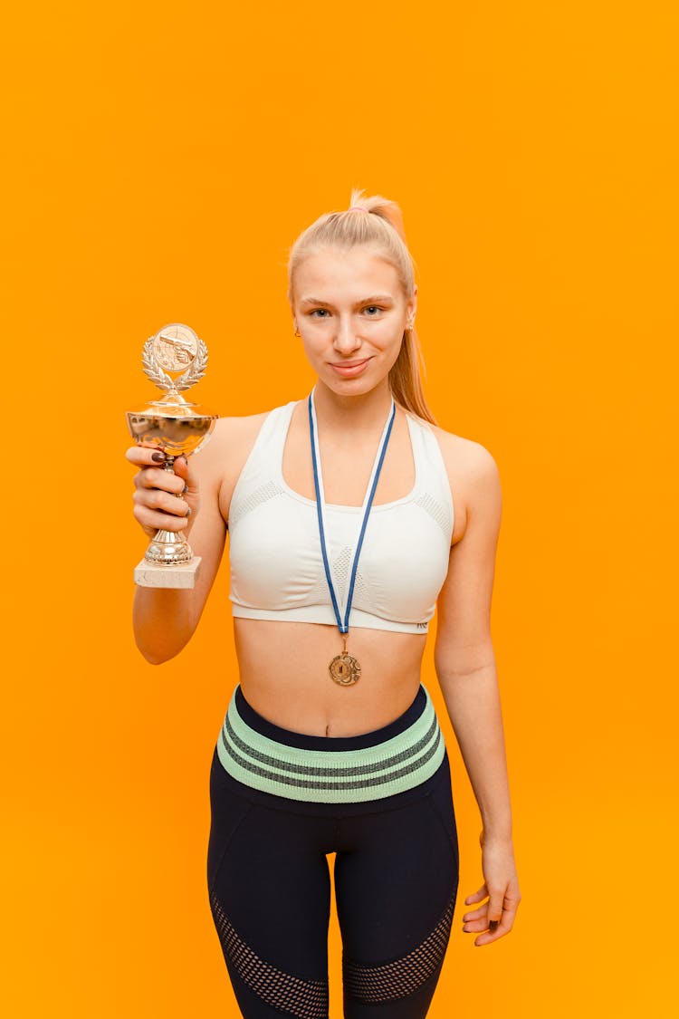 A Woman Holding A Trophy 