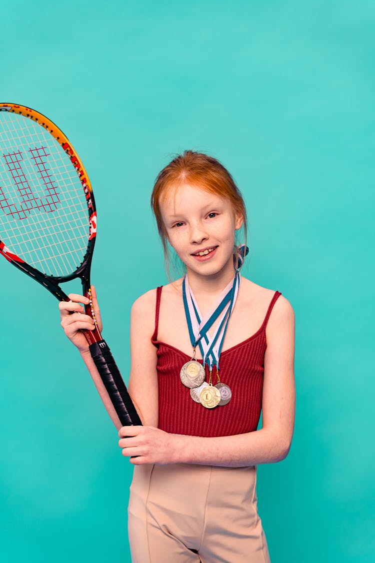 A Girl Holding A Tennis Racket 