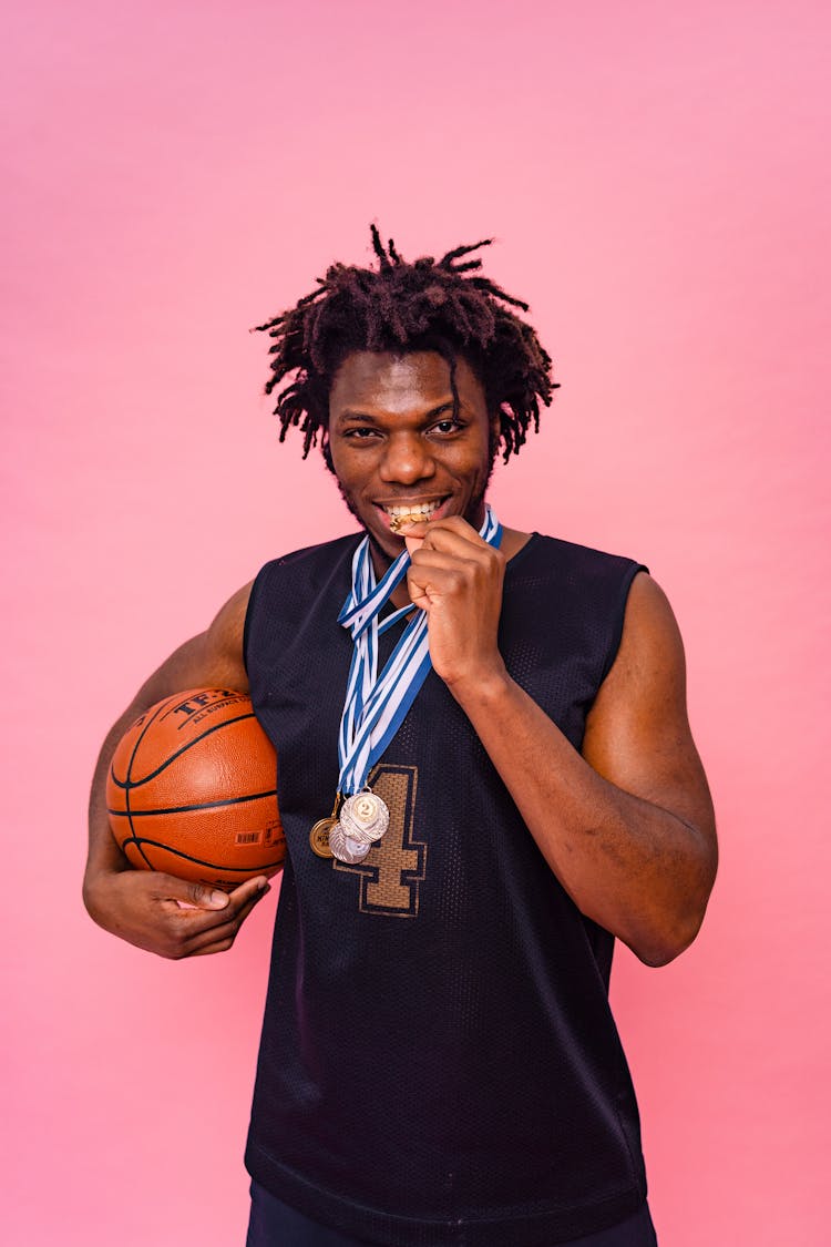 A Man Biting A Medal