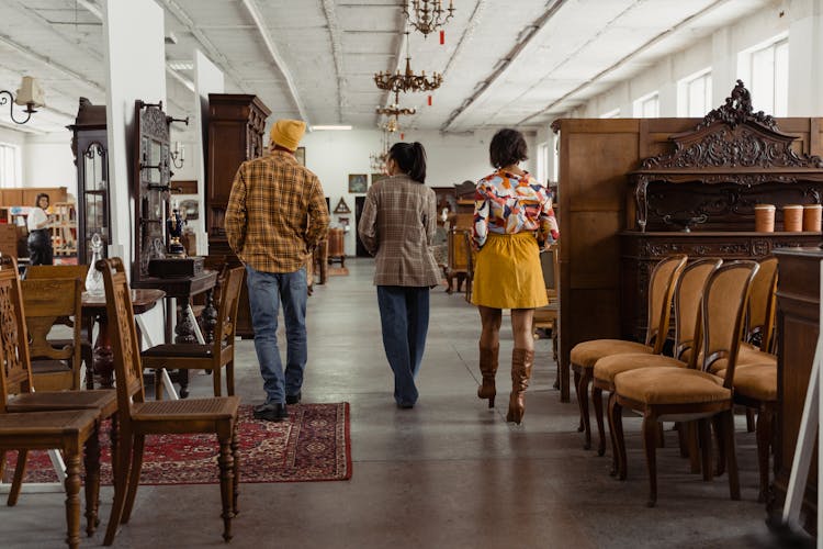 Back View Of People Walking In The Furniture Store