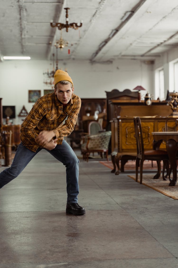 A Man In Plaid Shirt Inside An Antique Shop