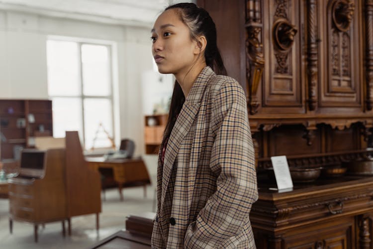 A Woman Wearing A Plaid Blazer