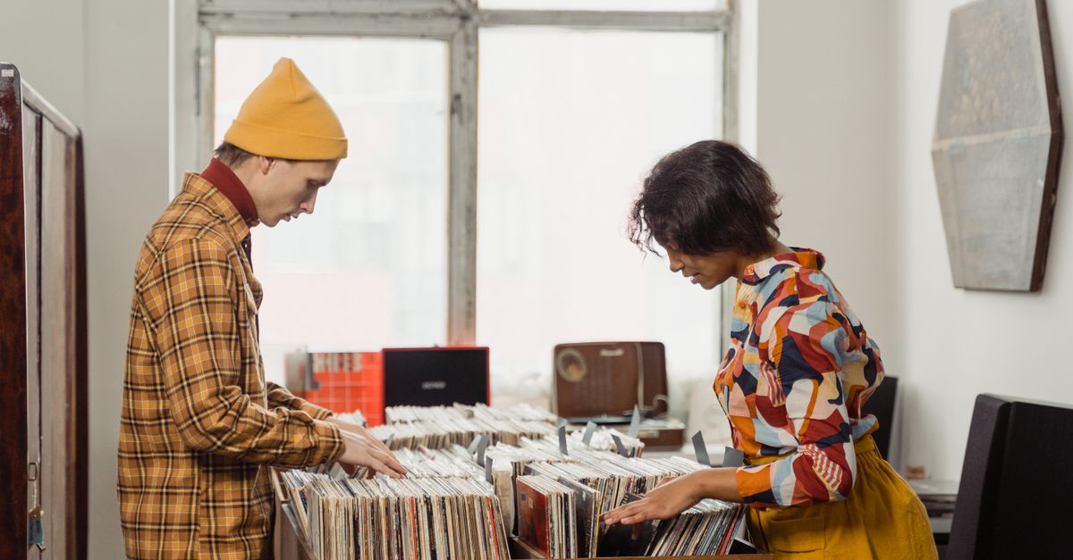 young woman browsing vinyl records in a vintage record store
