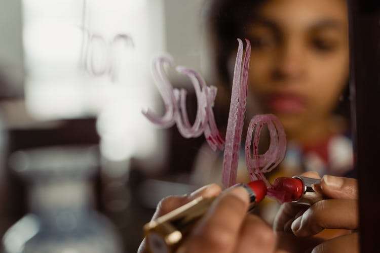 Close-up Of Lipstick Writing On Mirror 