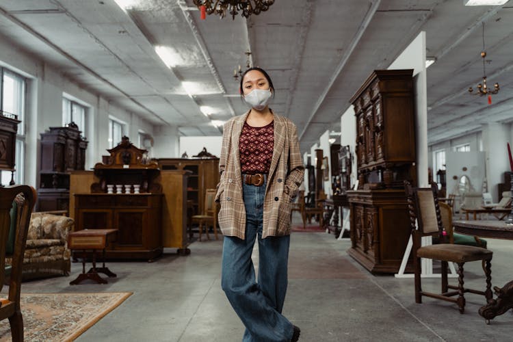 A Woman Standing Inside A Furniture Store