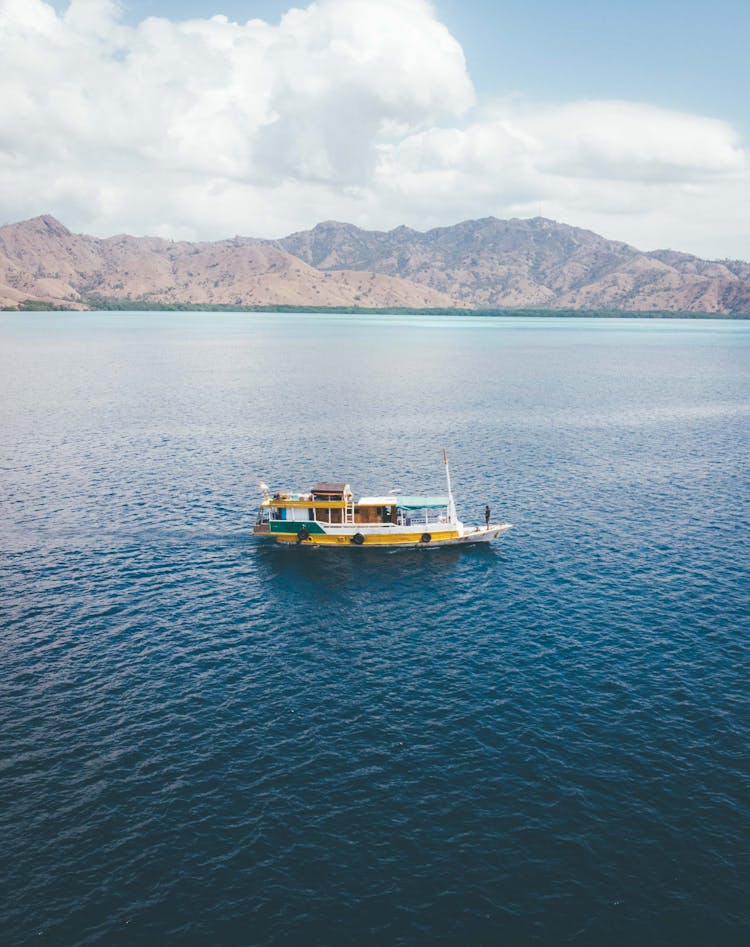 Boat Sailing In Endless Tranquil Water Of Sea