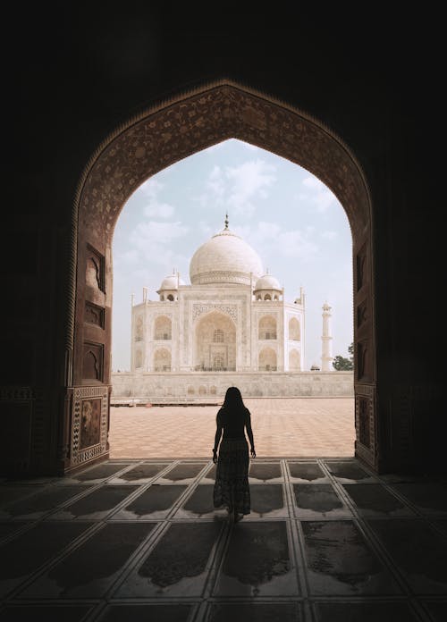 Woman Admirning the Majestic Taj Mahal 