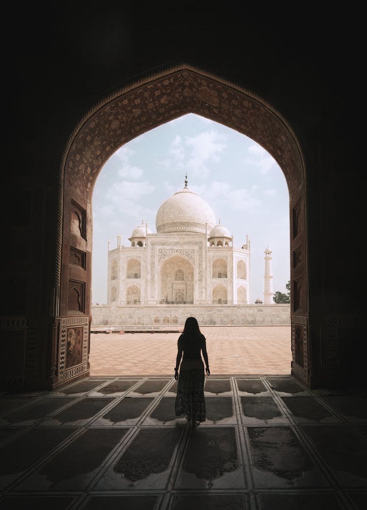 Woman Admirning The Majestic Taj Mahal 