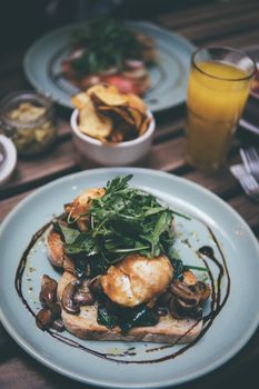Delicious brunch featuring poached eggs on toast with mushrooms and arugula, perfect for a healthy meal.