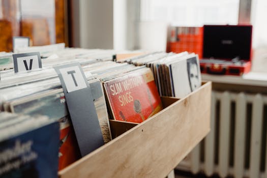 Explore a nostalgic collection of vintage vinyl records displayed in a wooden crate indoors.
