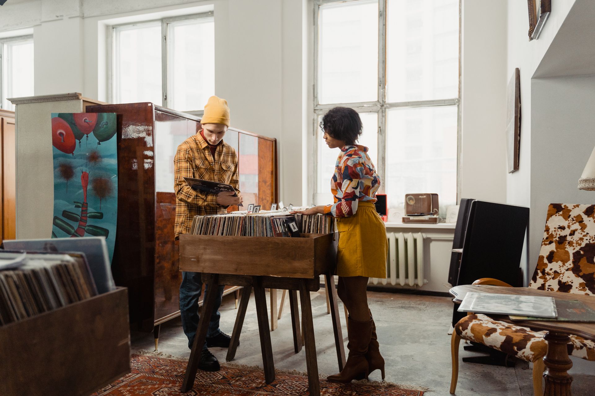 Man and Woman Choosing From A Pile of Vinyl Records