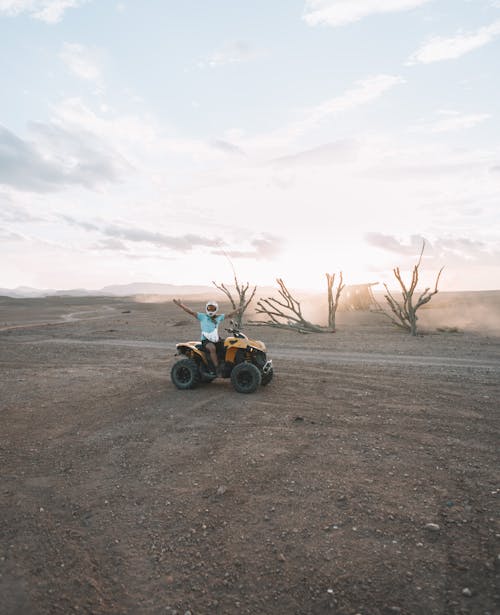 Free A Person Riding ATV in the Desert Stock Photo