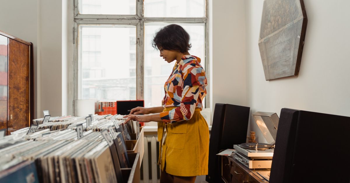 young woman browsing vinyl records in a record store
