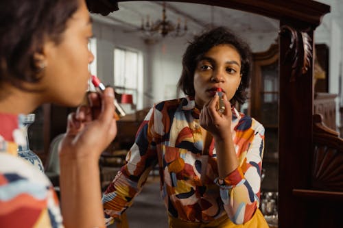 A Woman Putting On Lipstick 