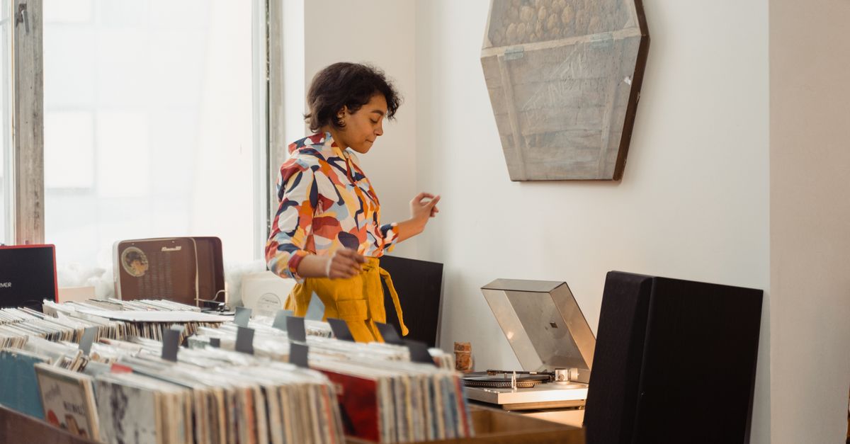 Gen Z teenager browsing vinyl records in a record store