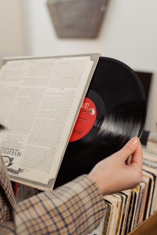Free A Person Looking at a Vinyl Record Stock Photo