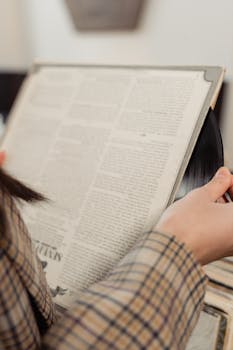 A close-up of a person holding a vintage vinyl record in a store, evoking a classic music vibe.