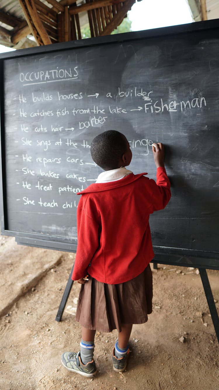 A Girl Writing On A Blackboard