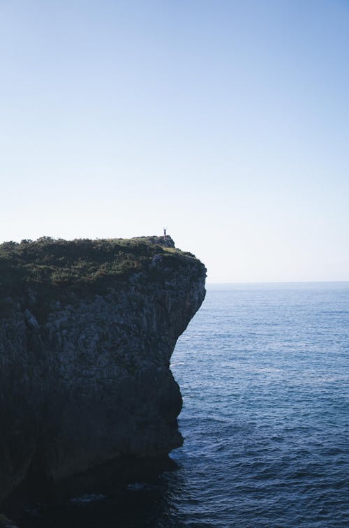 Free Person Standing on the Coastal Cliff  Stock Photo