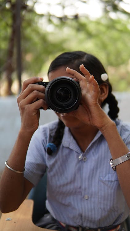 Shot of a Girl with Braids Taking a Photo