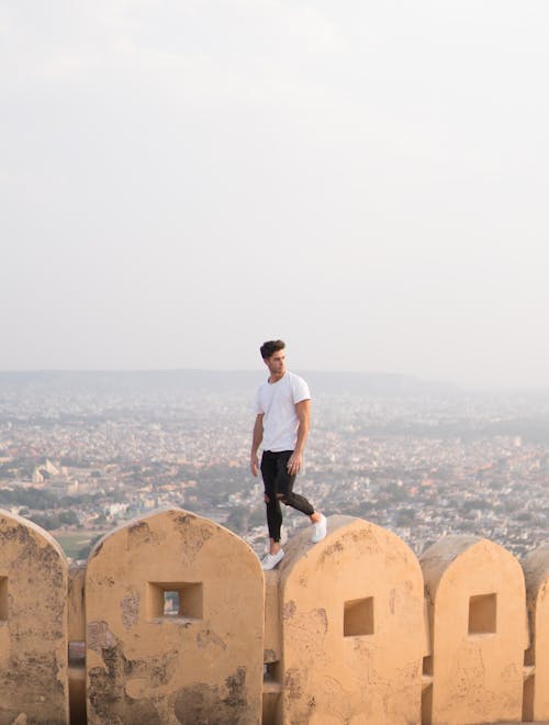 Young Man Standing on a Wall