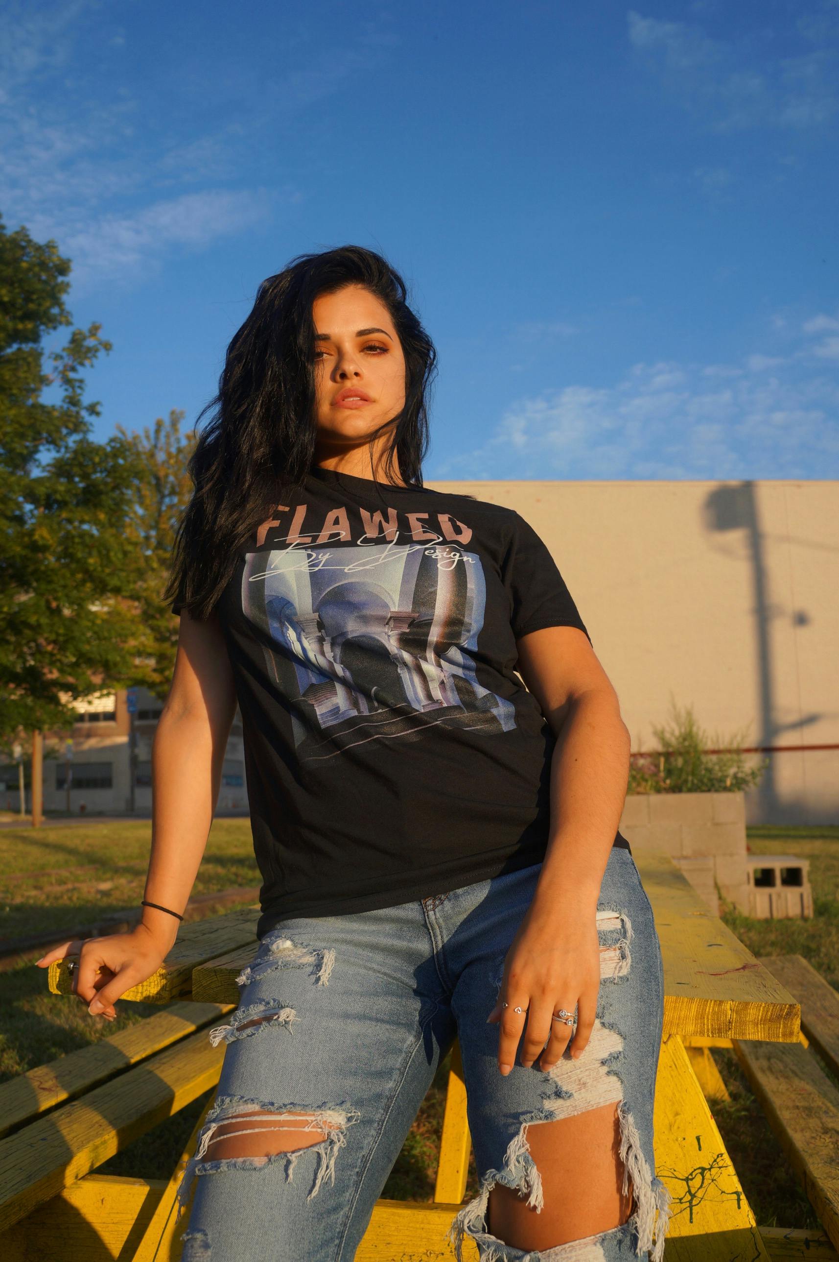 Fashionable woman in ripped jeans enjoying the outdoors in urban Ohio sunshine.