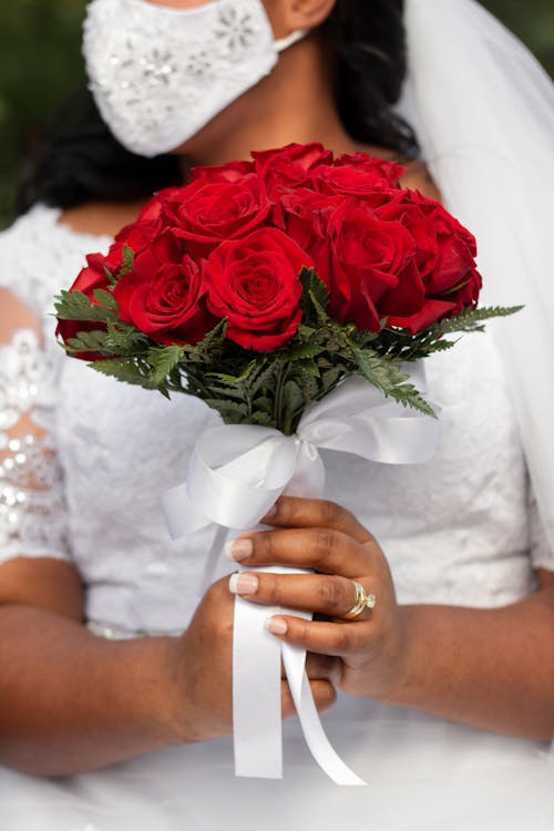 A Woman Holding Red Rose Bouquet · Free Stock Photo