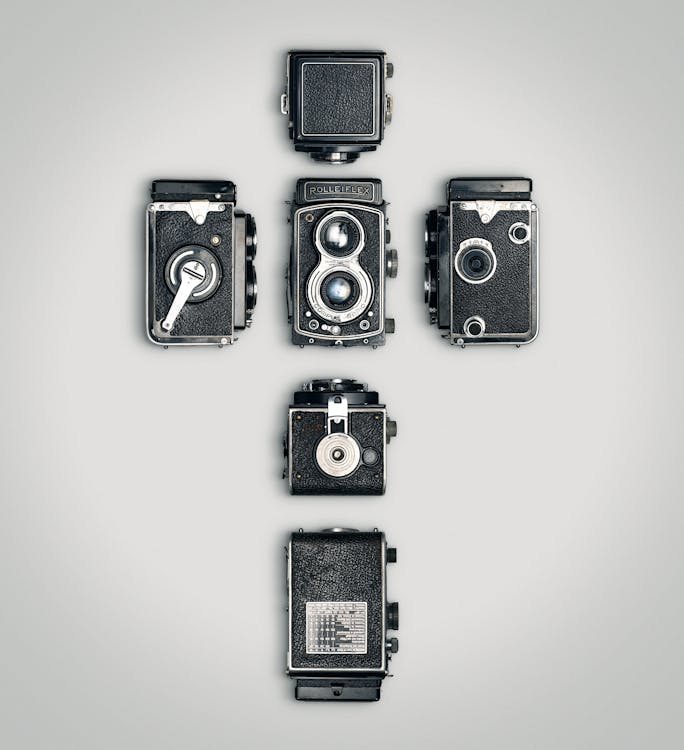 Vintage Cameras over White Surface