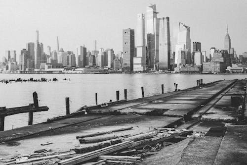 Free Grayscale Photo of Body of Water Near City Buildings Stock Photo