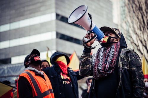 Black protesters in medical masks on street