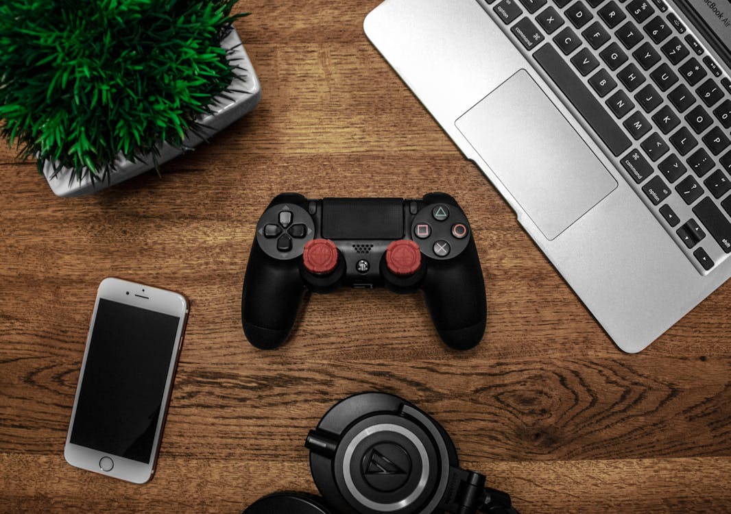 Free Black Game Console on Wooden Surface Stock Photo