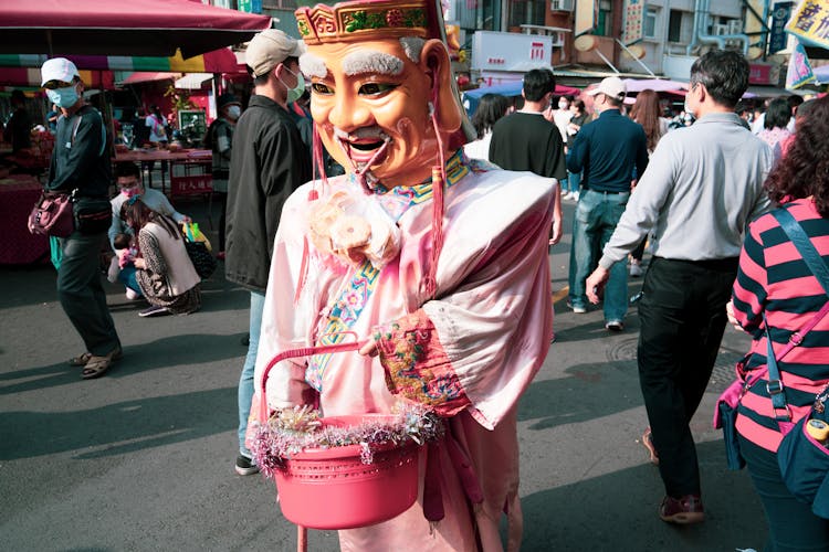 A Person Wearing Mask While Holding Pink Basket