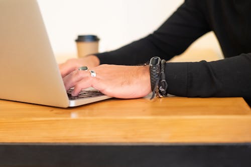 A Person Typing on a Laptop