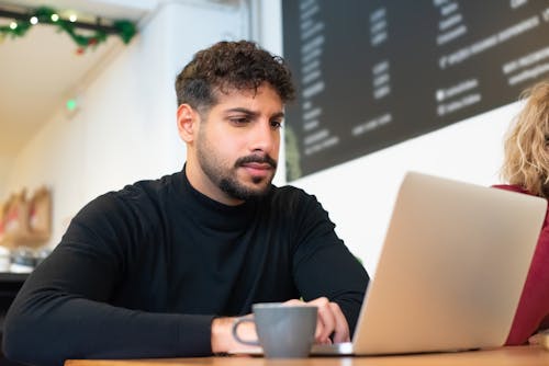Free A Bearded Man Using a Laptop Stock Photo