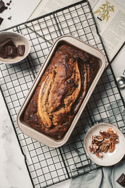 Baked banana bread in a rectangular loaf pan, overhead view`