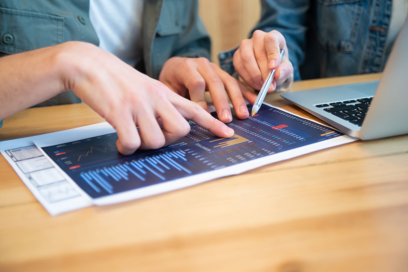 Business professionals comparing analytics reports and charts