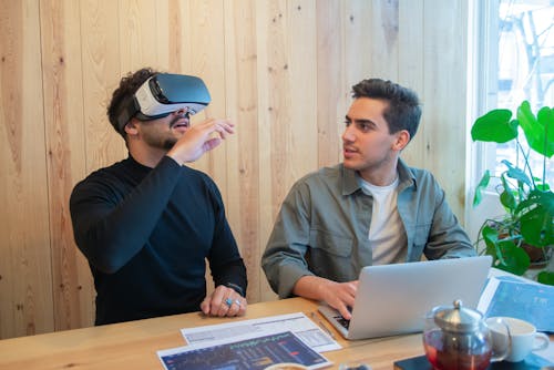 A Man Using a Virtual Reality Glasses at Work