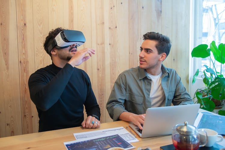 A Man Using A Virtual Reality Glasses At Work