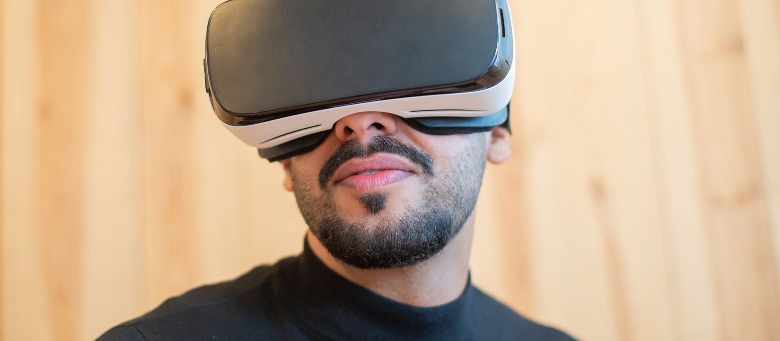 Close-up of a man wearing a virtual reality headset indoors, showcasing modern technology.