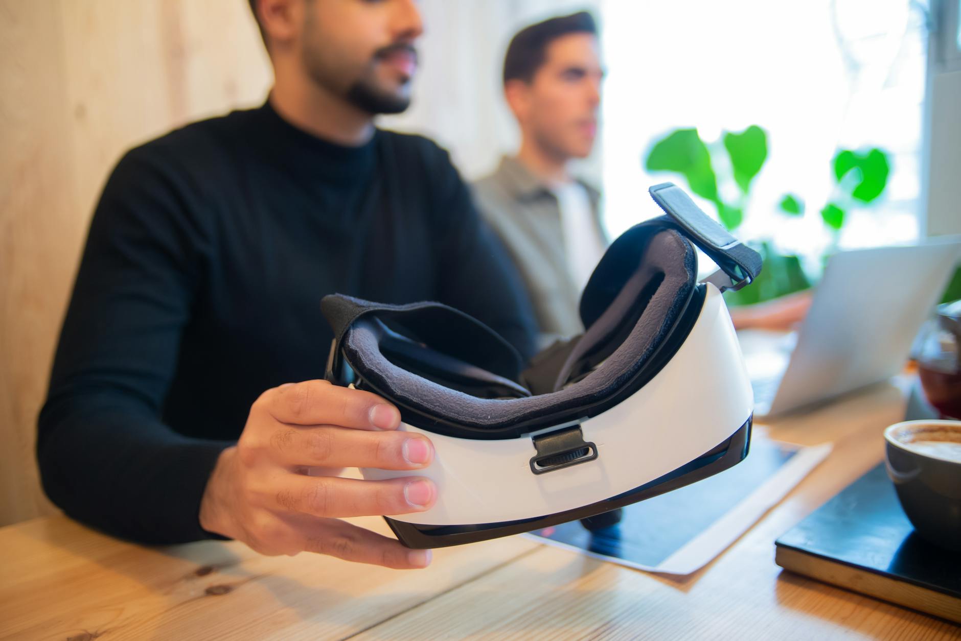 Professional team exploring virtual reality headset in an office setting for innovative solutions.