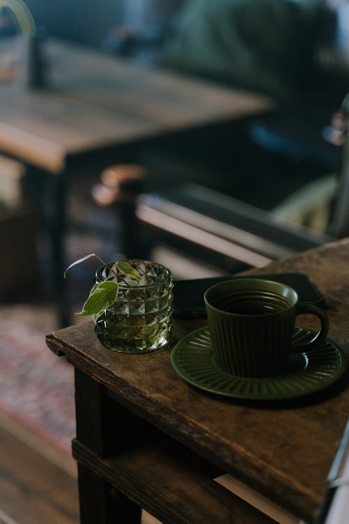 A Green Ceramic Cup on the Wooden Table