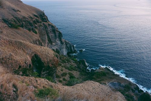 Free Beautiful rugged cliffs meeting the vast ocean in East Nusa Tenggara, Indonesia. Stock Photo